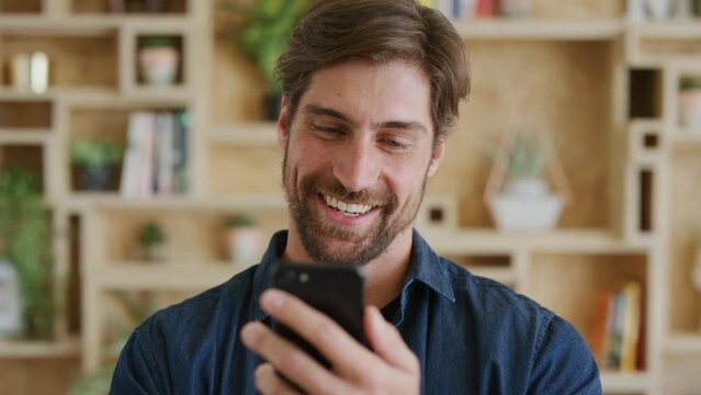 Social media, comic communication and man with a phone for internet, mobile chat and app in a house. Technology, funny and face of a person with a smartphone for conversation online with wifi