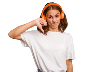 Young caucasian woman listening to music with headphones isolated showing a dislike gesture, thumbs down. Disagreement concept.
