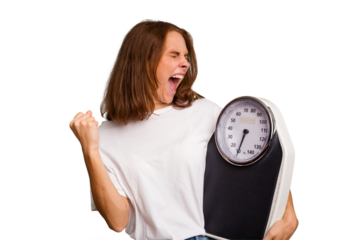 Young caucasian woman holding a scale and measure tape isolated raising fist after a victory, winner concept.