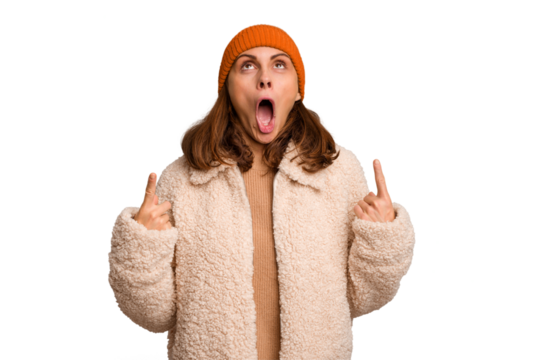 Young caucasian woman wearing winter clothes isolated pointing upside with opened mouth.