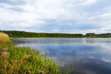 Fototapeta na wymiar Hirschler pond near Clausthal-Zellerfeld in the Harz Mountains. Landscape with a small lake and idyllic nature. 
