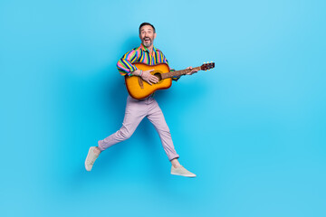 Fototapeta na wymiar Full length photo of cheerful charismatic man playing concert festive band vocalist isolated on blue color background