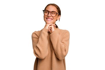 Young caucasian woman isolated keeps hands under chin, is looking happily aside.