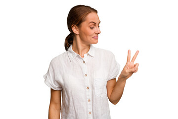 Young caucasian woman isolated joyful and carefree showing a peace symbol with fingers.