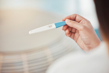 Woman, hands and pregnancy test with negative results, information and lines at home. Closeup of girl check infertility with stick for maternity, family planning and ovulation for prenatal healthcare