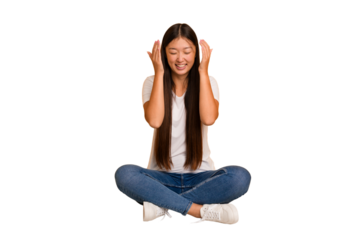 Young asian woman sitting on the floor cutout isolated joyful laughing a lot. Happiness concept.