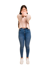 Young asian woman standing, full body cutout isolated doing a denial gesture