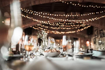 Fotobehang Hotel chique Beautiful wedding room with wedding table with food, flowers anddrinks, decorations,lights   © Dominik