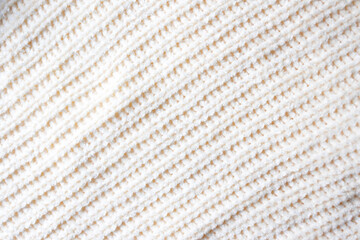 Fashionable knitted woolen fabric, abstract background. The texture of a soft warm sweater...
