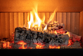 Fireplace close up, fire flame and burning wood log, warm home in winter