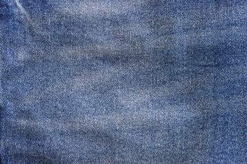 close up of worn blue jeans cloth fabric