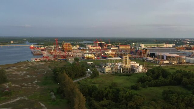 Aerial elevation shot capturing Petron Lumut POME Plant and Grade one marine shipyard at lumut port industrial park
massive ship building and repair hangars and hardstands, State of Perak, Malaysia.