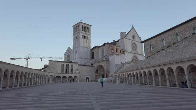 View on Basilica of Saint Francis of Assisi in Umbria and its portico from Plaza of Saint Francis. This catholic basilica is located in Umbria, region part of central Italy. Dolly move.