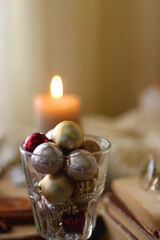 Cup of tea or coffee, various sweets and spices, Christmas decorations, comfy blanket, books and glasses. Selective focus.