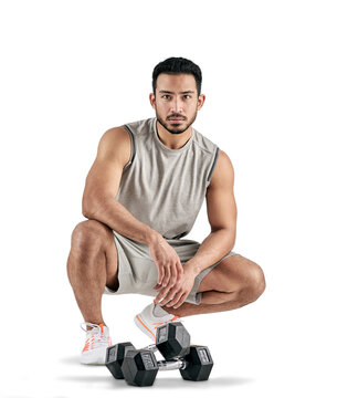 PNG studio portrait of a muscular young man posing with dumbbells.