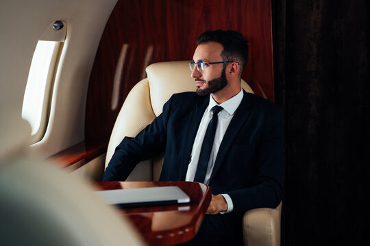 Businessman flying on his private jet. Concept about business, and transportation. Company young CEO going to an international business meeting conference with the private airplane