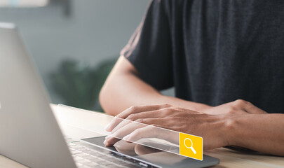 Businessman working on laptop with search engine browsing internet with empty search bar. Search...