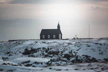 Bakirkja, Snfellsnes Peninsula, Iceland, Black church surrounded by snow, frozen nature and mountains