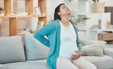 Pregnant woman, breathing and stomach pain on sofa in living room for childbirth wellness,...