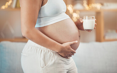 Woman, pregnant stomach and glass of milk for nutrition, wellness or healthy diet of future baby....