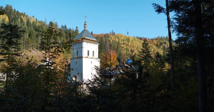 Manyava Skete of Exaltation of Holy Cross in forest in Carpathian mountains, Ukraine. Orthodox solitary cell mens monastery, skete. Near skete in the wood there is Blessed Stone, object of worship