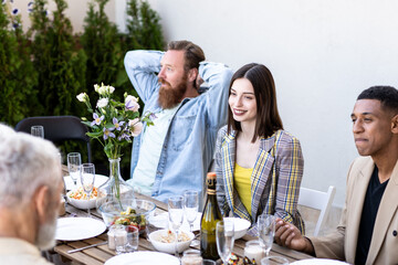 Family and friends celebrating at dinner on a rooftop terrace