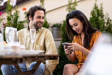 Family and friends celebrating at dinner on a rooftop terrace