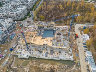 Aerial Flight Over a New Constructions Development Site with High Tower Cranes Building Real...