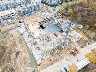 Aerial view of construction site with crane and building. Top view of big development construction...
