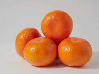 Ripe tangerines close-up on a white background.