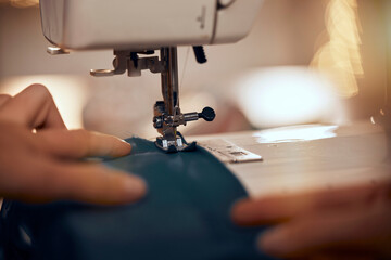 Design, clothes and closeup of sewing machine with fabric for clothing production, fashion design and tailor. Manufacturing, creative and hands of fashion designer working with textile in workshop