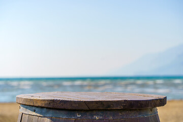 Wooden table on sea and blue sky background. Place for displaying goods against the backdrop of a...