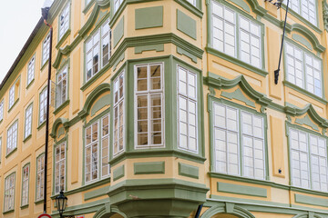 Obraz premium Corner of the house of classical European architecture of the old cozy tourist city. Background with selective focus