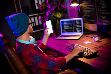 Photo of thoughtful minded guy dressed glasses hat shopping modern device empty space indoors...