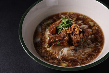 Braised pork noodles Thai street food isolated in black background