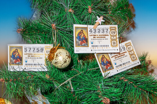 Zaragoza, Spain, December 2022; three national Christmas lottery tickets hanging on the Christmas tree.