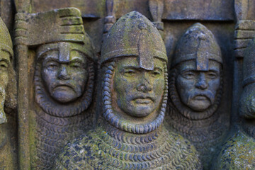 Ancient bas-reliefs in the architecture of the city. Historical and cultural heritage. Background with selective focus