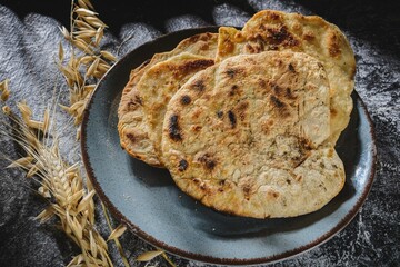 Dark background on the table. Exotic cuisine still life- indian food roti