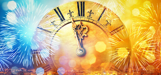 Retro clock close to midnight, fireworks and lights. New Year's and Christmas holiday background....