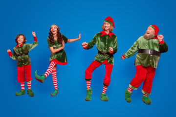 Full body photo of positive childhood elf people dance xmas wear hat holiday enjoy isolated on red color background