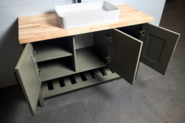 Solutions for placing things in bathroom opened locker drawers with doors shelves storage in plywood cupboard under stoneware washbasin cabinet under sink faucet. Modern loft flat minimalistic design.