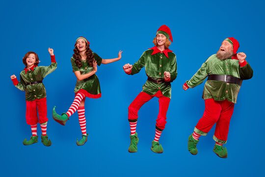 Full Body Photo Of Positive Childhood Elf People Dance Xmas Wear Hat Holiday Enjoy Isolated On Red Color Background