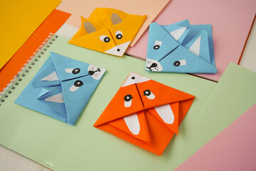 DIY and kid's creativity, origami. Colorful paper bookmarks corners in the form of animals.