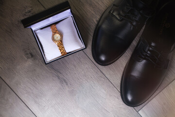The concept of preparing for the wedding. Men's shoes with women's watches