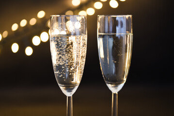 Den Helder, netherlands. december 2022. Tw glasses of champaign with a background with bokeh.