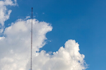 A radio antenna made of steel frame sits on the left side of the image, with a sling attached to...