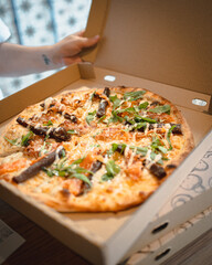 Open pizza box with cheese pizza inside