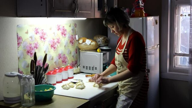 girl cooks in the kitchen sculpts dinner for the holiday from dough