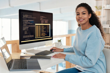 Portrait of cheerful young woman working on new software