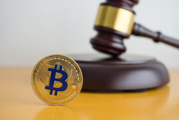 Bitcoin and hammer judge gavel on yellow table with white wall background copy space. Bitcoin...